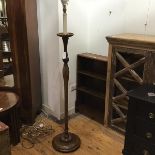 A 1930s walnut standard lamp, with candle style fitting, with drip tray, on turned and fluted