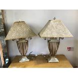 A stylish pair of patinated finish table lamps, with open metalwork vase shaped bodies, with