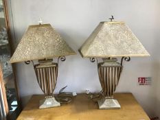 A stylish pair of patinated finish table lamps, with open metalwork vase shaped bodies, with