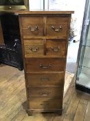 A 19thc style hardwood bank of drawers, the plain square top above four drawers, with brass drop