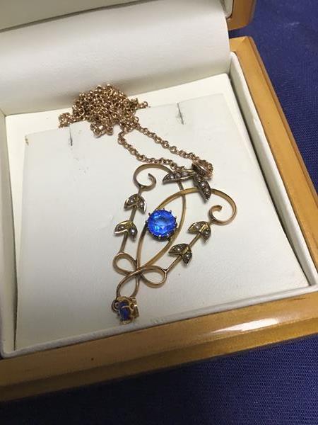 A 9ct gold Edwardian lady's pendant set blue stones and pearls, on 9ct chain (5.2g)