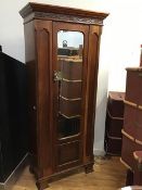 An early 20thc mahogany single door wardrobe, the dentil cornice above a retwork frieze and a single