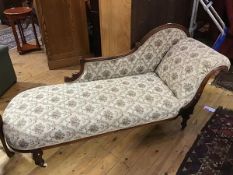 A late Victorian walnut chaise longue, the upholstered curved back, with moulded and carved top