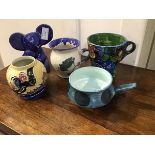 A mixed lot of handpainted Studio Pottery including a large handpainted breakfast cup with floral