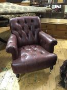 A club style pholstered oxblood leather button back armchair, the plain button back with scroll arms