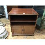 A 1920s mahogany side table, the rectangular top with moulded edge above an open recess fitted