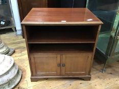 A 1920s mahogany side table, the rectangular top with moulded edge above an open recess fitted