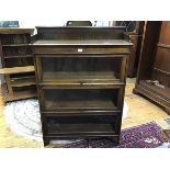A 1920s bookcase, the ledgeback top with plain frieze above three shelves with retractable/
