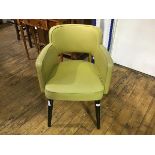 A 1940's/50's yellow vinyl upholstered armchair with splay tapered ebonised supports (h.78cm)