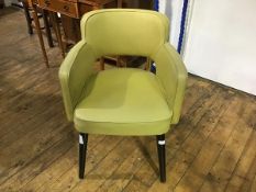 A 1940's/50's yellow vinyl upholstered armchair with splay tapered ebonised supports (h.78cm)