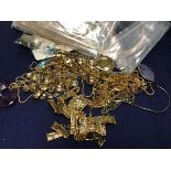 A bag containing a mixed lot of mainly gold plated jewellery including necklaces, pendants etc. (a