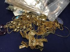 A bag containing a mixed lot of mainly gold plated jewellery including necklaces, pendants etc. (a