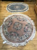 A Chinese finely knotted circular wool rug, with flowerhead and floral border, pink field,