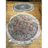 A Chinese finely knotted circular wool rug, with flowerhead and floral border, pink field,