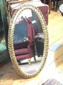 An Edwardian style oval gilt framed wall mirror (104cm x 57cm)