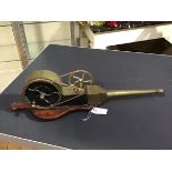 A late 19thc brass hand cranked mechanical bellows, mounted on a mahogany base (l.64cm)