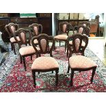 A set of eight modern dining chairs, made by SimBeck of High Wycombe, each arched back with padded