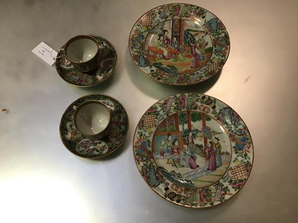 A pair of 19thc Chinese Exportware famille rose decorated dishes, the centre panel with scenes of