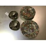A pair of 19thc Chinese Exportware famille rose decorated dishes, the centre panel with scenes of