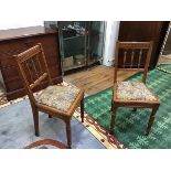 A pair of late Victorian walnut side chairs, each with dentil top rail and turned spindle back,
