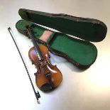 A modern stained child's practice violin complete with bow and case