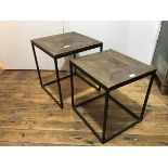 Two modern graduated tables, each square moulded top raised on a metal base, united by stretchers (