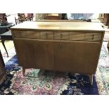 A 1950s side cabinet by Lebus, the rectangular top above a pair of fluted front frieze drawers, with