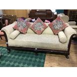 A 1920s mahogany framed three seater sofa, the upholstered back, arms and seat with additional