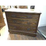 An Edwardian stained ash chest of drawers, the rectangular top above three graduated drawers, raised