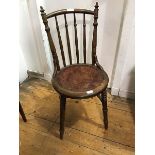 A late 19thc bentwood cafe chair with turned spar back and perforated seat, on turned front legs