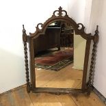 A 1920s oak hanging wall mirror with barley twist supports and arched moulded frame (80cm x 60cm)