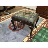An Edwardian mahogany footstool of George III design, the rectangular grospoint tapestry seat