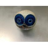 A pottery owl with blue enamelled eyes (h.8cm x 8cm x 6cm)