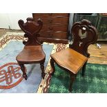Two mid Victorian mahogany hall chairs, the first with shield shaped back, shaped seat and