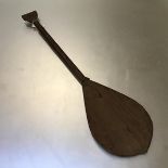 A wooden ceremonial paddle, possibly Australian, undecorated (h.104cm x 27cm)