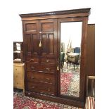 A Victorian figured walnut wardrobe by Maple & Co., London and Paris, the dentil cornice above a