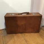 A leather suitcase with canvas lined interior (some stains and marks), stamped, Made in England (