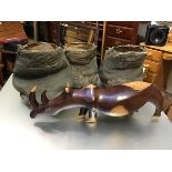 Taxidermy: three various elephant feet (largest: h.41cm x 44cm x 38cm) and a carved hardwood