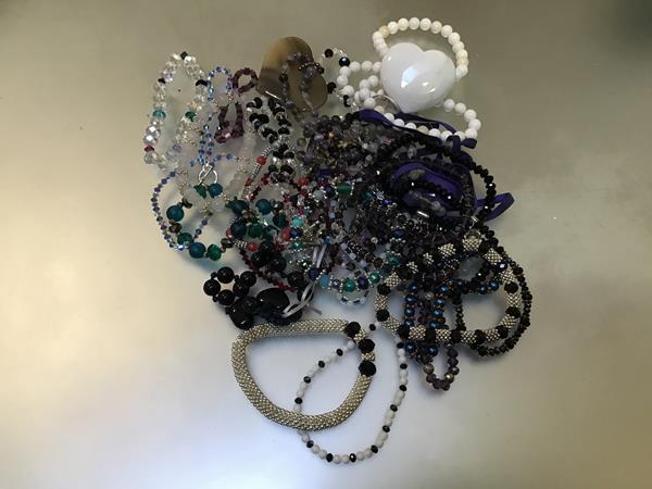 An assortment of costume jewellery including quartz and rose quartz bracelets, bead necklaces,