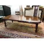 A Victorian style telescopic dining table, the rectangular top with moulded edge enclosing two