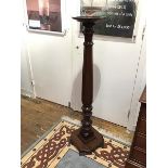 An early 20thc mahogany torchere, the circular dish top on a baluster stem, with gadroon detail on