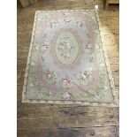 An Aubousson style tapestry banner with central medallion decorated with roses within a pale pink