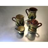 A Devon motto ware pottery hot milk jug, a small teacup and jug and a thistle decorated jug (