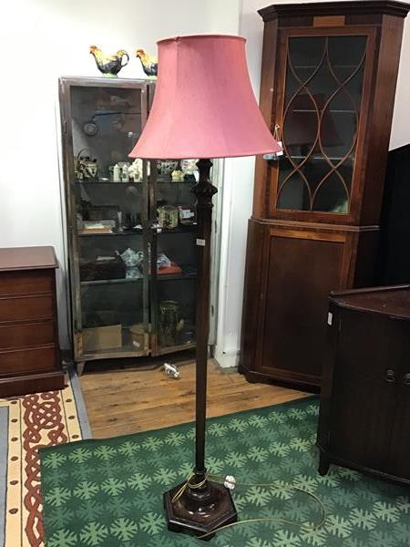 A mid 20thc wooden floor lamp, the faceted octagonal column with gadroon details and trailing