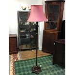A mid 20thc wooden floor lamp, the faceted octagonal column with gadroon details and trailing
