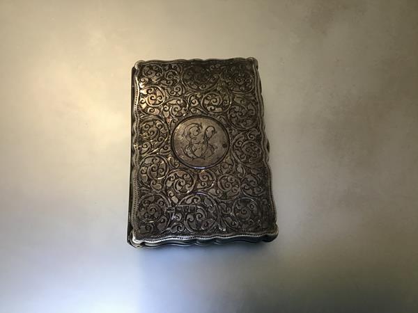 A Victorian aide memoire with Chester silver cover with allover engraved boteh and S scroll