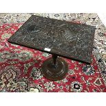 An unusual occasional table, the top made from an oak panel carved in the centre with a cockeral,
