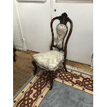A late Victorian rosewood side chair, the oval back incorporating a pierced fretwork panel, with