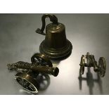 Two miniature brass canons, one marked 1812 and a cast brass signal bell complete with knocker (