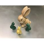 A set of four rabbits, one stamped Sylvac decorated with green and yellow glaze (tallest: 12.5cm)
